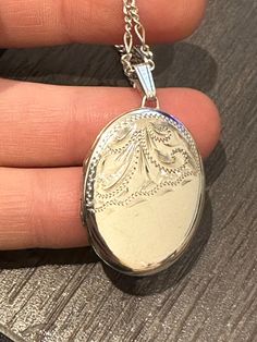 Here is a beautiful vintage solid silver locket. It has a lovely front panel of etched scrolls on the front , It measures approximately 4cm in height including the bail and 2.3cm in width. It remains in excellent condition with no damage. I have put it on a 18 inch silver chain. Classic Pendant Locket Necklace With Intricate Design, Oval Locket Necklace With Intricate Design For Anniversary, Ornate Oval Engraved Locket Necklace, Ornate Engraved Oval Locket Necklace, Elegant Silver Locket Necklace Stamped 925, Silver Oval Pendant Locket Necklace, Oval Sterling Silver Locket Necklace, White Gold Oval Pendant Locket Necklace, Antique Silver Sterling Silver Oval Locket Necklace