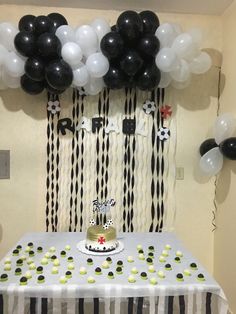 a birthday party with black and white balloons