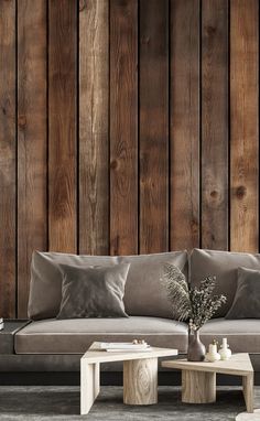 a living room with wood paneling and two tables in front of the couches