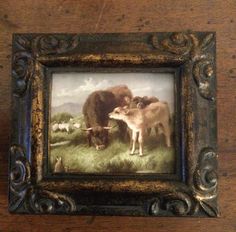 there is a painting on the wall with animals in it and one cow standing next to another