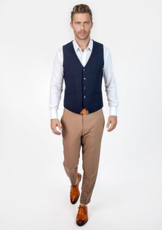 This Navy Blue Vest is designed with stretch cotton for comfort, and features a classic, vibrant navy blue color that is timeless in style. Its versatility allows you to level up any outfit, making it a must-have wardrobe staple. Formal Navy Cotton Outerwear, Elegant Blue Cotton Outerwear, Slim Fit Cotton Outerwear For Business Casual, Fitted Cotton Outerwear For Business Casual, Blue Cotton Outerwear For Business Casual, Business Casual Blue Cotton Outerwear, Fitted Navy Outerwear For Business Casual, Fitted Cotton Outerwear For Semi-formal Occasions, Navy Blue Vest