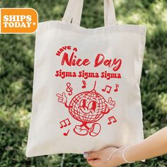 a person holding a white bag that says nice day, stigmaa signa on it