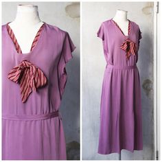 Bust: 42"  Waist: 36"  Hips: 44"  No closure. This elegant 1920s dress in a rare plum purple color features a red striped tie that adds a charming touch. The dress can be worn with or without tying the bow, both ways looking cute. Issues: There are some watermarks (easy to clean), stains on the dress, and flaws around the armpits. Feel free to ask for more photos or videos before making a purchase. The dress is in nice condition. - 【Please take note of the following guidelines before making a pu Casual 1920s Outfit, Purple Flapper Dress, 1920s Dress, Rayon Dress, Dropwaist Dress, 1920s Fashion, Plum Purple, Striped Tie, Historical Clothing