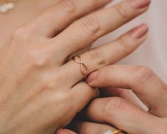 Discover the elegance of our Infinity Artisan Ring, meticulously handcrafted by our cherished artisans in our Northern California studio, employing sustainable and eco-friendly practices. This ring, available in 14 karat rose gold filled, 14 karat yellow gold filled, and .925 sterling silver, measures 1/2" long by 3/16" tall. Its delicate open infinity design gracefully encircles the finger, symbolizing everlasting connections. Handcrafted with meticulous artistry, it embodies the enduring natur Minimalist Rose Gold Infinity Ring, Elegant Stackable Rings In Recycled Gold As A Gift, Adjustable 14k Rose Gold Rings For Gifts, Hypoallergenic Rose Gold Wedding Rings, Hypoallergenic Rose Gold Jewelry In Recycled Gold, Hypoallergenic Rose Gold Jewelry From Recycled Gold, Hypoallergenic Recycled Rose Gold Jewelry, Rose Gold Minimalist Promise Jewelry, Rose Gold Hypoallergenic Promise Jewelry