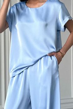 Light blue 2 piece satin loose fit set stylish and elegant!  The suit consists of a crew neck top with short sleeves and palazzo trousers with convenient pockets.  The suit will be an excellent choice for various occasions for an elegant casual look for every day, walks, as well as for special occasions for wedding guests, parties, family celebrations, receptions and more.    DETAILS - light blue  - satin  - loose fit - crew neck - short sleeve - wide leg   SIZES   This suit is available in 4 sizes S, M,  L and XL  T-shirt back length 24"/ 61 cm Shoulder 4.7"/ 12 cm  Pants inseam 29"/ 74 cm Outseam 41.33"/ 105 cm    S BUST 34 inches / 88 cm WAIST 26 inches /67 cm HIPS 37 inches / 96 cm M  BUST 36 inches / 92 cm WAIST 28 inches / 71 cm HIPS 39 inches / 100 cm L BUST 37.8"/ 96 cm WAIST 29.5" Satin Pant Suit Women, Elegant Solid Color Short Sleeve Sets, Elegant Short Sleeve Sets, Blue Satin Sets For Summer, Elegant Silk Short Sleeve Sets, Elegant Short Sleeve Satin Set, Summer Silk Sets With Short Sleeves, Pantsuit Wedding Guest, Satin Pantsuit