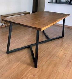 a wooden table sitting on top of a hard wood floor