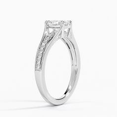 a white gold engagement ring with princess cut diamonds