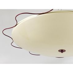 a white ceiling light with red cord hanging from it's center and two lights on each side