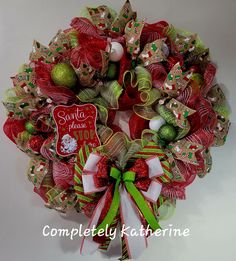 a christmas wreath with green and red decorations