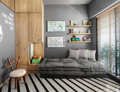 a living room with grey walls and black and white striped rugs on the floor