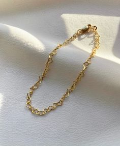 Delicate 14kt gold filled heart chain bracelet. The delicate and minimalist design of this link bracelet goes well with both casual and sophisticated looks. Wear it on its own or layered with other bracelets in our shop. Perfect for a gift! ✦ MATERIALS ✦ 14kt gold filled heart chain and lobster claw clasp. ✦ SIZING ✦ Available in 3mm width. ✦ PACKAGING ✦ All orders are packed in jewelry boxes/pouches with a brand logo, which makes it perfect for gifting. All packaging materials including mailers Heart Link Bracelet, Minimalist Adjustable Chain Bracelet For Valentine's Day, Minimalist Heart Bracelet With Adjustable Chain For Everyday, Minimalist Heart Bracelet With Adjustable Chain, Gold Heart Bracelet With Adjustable Chain, Delicate Heart Bracelet With Chain For Everyday Wear, Everyday Gold Heart Bracelet With Adjustable Chain, Minimalist Everyday Heart Bracelet With Adjustable Chain, Delicate Heart Bracelet With Delicate Chain For Everyday