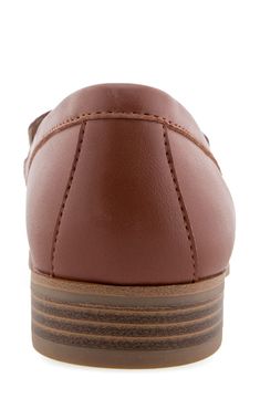 An almond toe adds modern polish to a classic loafer-inspired flat with an embossed vamp and a shock-absorbing sole. Synthetic upper, lining and sole Imported Modern Brown Slip-on Flats, Flat Heel Synthetic Oxfords With Textured Sole, Synthetic Oxfords With Textured Sole And Flat Heel, Brown Moccasins With Cushioned Footbed And Flat Heel, Medium Width Synthetic Loafers With Round Toe, Brown Synthetic Oxfords With Rubber Sole, Synthetic Loafers With Almond Toe, Medium Width, Synthetic Loafers With Medium Width And Almond Toe, Brown Synthetic Flats With Rubber Sole