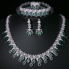 Experience the epitome of elegance with our Luxury Emerald Bridal Jewelry Sets. These exquisite pieces feature captivating green emerald-like stones crafted from AAA Cubic Zirconia, meticulously set in a pendant necklace and coordinating earrings. Designed to enhance your allure at any special occasion, from weddings to glamorous parties and elegant dinner events, these sets embody a timeless sophistication. Style: TRENDY Shape\pattern: Geometric Occasion: Wedding Metals Type: Copper Alloy Mater Emerald Bridal Jewelry, نظارات شمسية, Jewellery Marketing, Cubic Zirconia Jewelry, Tassel Jewelry, Wedding Bridal Jewellery, Luxury Bridal, Wedding Collection, Dress Jewelry