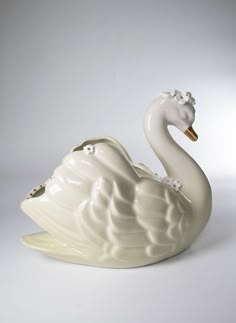 a white swan figurine sitting on top of a table