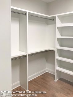 an empty walk in closet with white shelving