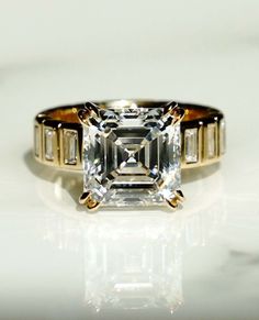 an emerald cut diamond ring with three baguets