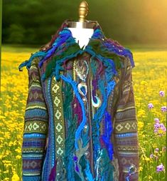 Fantasy bohemian sweater Jacket🦚 in darker blues, purple and turquoise colors for  unique style admirers. Bust: 44" ( 112 cm), Hips: 45" (114 cm). Sleeves length: 24" (61 cm), Circumference of the upper sleeve is 16"(41 cm), The length: 25"- 29" (64 - 74 cm). How to take care of this sweater Jacket? Soak your jacket in lukewarm water for 20 minutes, then gently rub on stains and needed area. Leave it flat to dry on fluffy towel.  Read my reviews before you make a purchase or ready to place a custom order. https://www.etsy.com/your/shops/amberstudios/reviews?ref=shop_info What customers say about Amber Studios Coats: "OMG... This is one of the most beautiful pieces of wearable art I have in my collection. I have my eye on another piece I will purchase soon.  Thank you Barbara for this gorg Fantasy Peacock, Boho Chic Hats, Wearable Art Clothing, Bohemian Sweater, Boho Pullover, Floral Sweater, Knitted Hood, Art To Wear, Unique Clothing