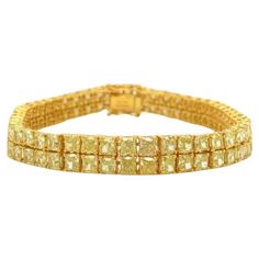 The Following Item we are offering is a Rare Important Radiant 18KT Gold Fancy Yellow Diamond Bracelet! This Magnificent Fancy Yellow Diamond Bracelet has over 11CTS of Fine Fancy Yellow Diamonds!! This Gorgeous Bracelet is a Rare Masterpiece from a Private Top Manufacturer that sold to Important Five Star Hotel Jewelry Stores and Fine Jewelry Stores and comes New With Tags $77,594! Luxury Yellow Rectangular Jewelry, Yellow Diamond Bracelet, Double Bracelet, Yellow Diamonds, Fancy Yellow Diamond, Five Star Hotel, Star Hotel, Diamond Gold, Gorgeous Bracelet