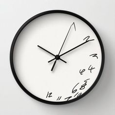 a black and white clock with writing on it