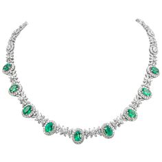 Beautiful emerald and diamond necklace. 19.10 carats total gemstone weight. 9 oval shaped emeralds, 6.53 carats, apx F2. 805 round and baguette cut diamonds, approximately G/H color and VS2/SI1 clarity. 18k white gold, 33.58 grams, 16.5 inches. Accommodated with an up-to-date appraisal by a GIA G.G. once purchased, upon request. Please contact us with any questions. Item Number N6682 Gucci Necklace Gold, Flat Gold Necklace, Emerald Jewelry Necklace, Emerald Diamond Necklace, Emerald And Diamond Necklace, Black Gold Necklace, Baguette Necklace, Silver Coin Necklace, Star Necklace Silver