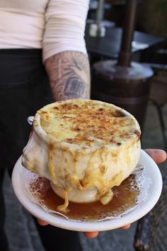 a person holding a plate with food on it