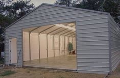 an empty garage with the doors open and no one inside or outside in front of it