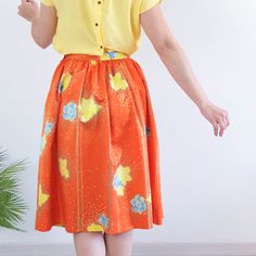 Amazing vintage 80's orange floral satin skirt with blue and yellow flowers print, dotted and pinstripe. This high waist circle skirt has retro style, it's 80's summer midi full skirt, it has yoke and side buttons and zip closure. The skirt is polyester fabric but only retains the old size label, is a used skirt and is not perfect for its age and delicate fabric, has some small loose threads and a small stain, but as its print is so striking is not much appreciated. The modern size is Small, the Retro Pleated Spring Skirt, Retro Pleated Skirt For Summer, Spring Orange Relaxed Skirt, Spring Orange Relaxed Fit Skirt, Retro Floral Print Summer Skirt, Retro Floral Print Skirt For Summer, Spring Full Skirt In Orange, Retro Gathered Summer Skirt, Retro Floral Print Skirt With Relaxed Fit