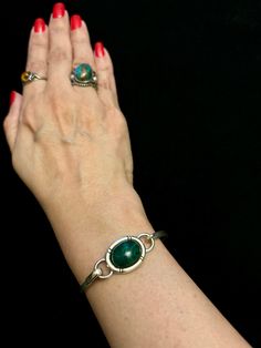 *For Sizing: this bangle bracelet will fit a small wrist size up to 6 1/4" inches.  Vintage Taxco Bangle Bracelet with Malachite Inlay Stone! Marked Mexico 925 and Taxco artisan hallmark (TB-20) on inside of bangle. Weight is at 18 grams. Please review all pictures.  Thank you for visiting my shop & don't forget to check out my other Vintage Beauties! If you like what you see, FAVORITE MY SHOP for new listings. I have excellent reviews on Etsy and other platforms. I am considered a recommended and fair seller. Mexicana / Taxco / Mexico / Sterling / Silver / Stampd / Native / Authentic Original Vintage / Unique Vintage / Siam Sterling Silver / Birthday Gift / Anniversary Gift / Christmas Gift / RosiesSilverLinings Green Sterling Silver Round Cuff Bracelet, Handmade Green Sterling Silver Bangle, Green Cabochon Bracelets As A Gift, Green Cabochon Bracelets For Gift, Sterling Silver Green Cuff Bracelet As Gift, Sterling Silver Cuff Bracelet In Green As Gift, Green Sterling Silver Cuff Bracelet As Gift, Green Sterling Silver Cuff Bracelet For Gift, Adjustable Green Sterling Silver Cuff Bracelet