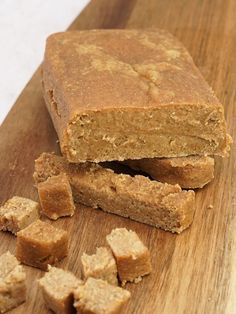 two pieces of peanut butter fudge on a cutting board next to some cubes