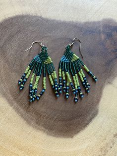 These gorgeous earrings are designed and produced in Kwazulu-Natal. Unique Green Teardrop Beaded Earrings, Unique Green Dangle Earrings, Green Dangle Earrings For Pierced Ears, Handmade Green Drop Plug Earrings, Adjustable Green Drop Plug Earrings, Unique Green Teardrop Earrings, Green Bohemian Earrings With Ear Wire, Unique Green Round Beads Earrings, Unique Green Round Beaded Earrings