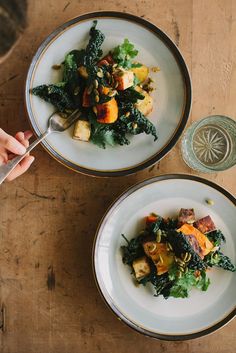 two white bowls filled with food on top of a wooden table