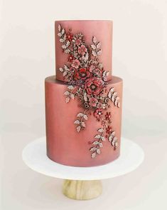 there is a pink cake with flowers on it