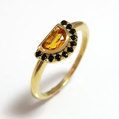 Majestic and romantic, this engagement rings will certainly sweep her off her feet. Handmade and designed in 14k yellow gold, A dazzling halo set with black spinel gems that highlight the center half-moon Citrine gem in this unique ring. #jonjonjewel #UniqueEngagementRing #CitrineRing #YellowBlackRing #NovemberBirthstoneRing #CitrineEngagementRing #MoonGemstoneRing Engagement Ring Moon, Gemstone Rings Unique, Boho Engagement Ring, Yellow Citrine Ring, Citrine Ring Engagement, Orange Gem, November Birthstone Ring, Turquoise Gold Ring, Mom Ring