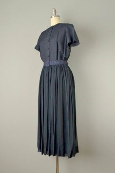 "A very chic dress from the 1950's made of luxurious silk chiffon over navy silk shantung with an exquisite texture. Features covered buttons up the front w/ snap closure at neckline, short sleeves, and back metal zipper. (Pictured with belt, not included.) Measurements → Size: Medium - Large Bust: 40\" Waist: 30\" Hips: 40 Length: 49.5\" Label: None. Condition: Excellent vintage condition. All vintage is sold in \"as-is\" condition. We do our best to inspect, correct, and list important flaws. Shantung Dress, Dress Navy Blue, 50s Dresses, 1950s Dress, Blue Silk, Metal Zipper, Large Bust, Silk Chiffon, Chic Dress