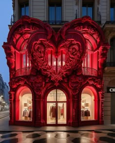 a red building with an intricately carved heart on the front