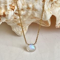 The moonstone briolette drop has a beautiful fiery, flashy blue hues. A great piece to wear every day. Delicate cable chain necklace accelerated with fiery rainbow moonstones . Length 14.5" Plain gold necklace with fiery rainbow moonstone drop. Length 17" adjustable to 16". Since ancient times it is said that Moonstone carries the energy of the new moon and enhances energies of the feminine goddess. It is claimed that holding this vibrant stone is like wearing a rainbow in your heart because of Gold Necklace With Moonstone Briolette, Unique Gold Moonstone Necklace, Gold Moonstone Briolette Necklace, Gold Spiritual Moonstone Crystal Necklace, Rainbow Moonstone Necklace, Birthstone, Ancient Times, Moon Stone, Cable Chain