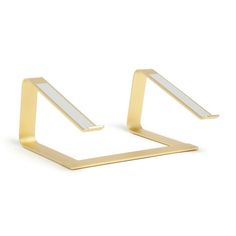 two gold geometric earrings on white background