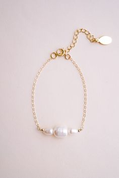 Introducing our Cosette Pearl Bracelet, a delicate and elegant piece of jewelry that is perfect for weddings or any formal occasion. This dainty gold chain bracelet features beautiful freshwater pearls that are hand wire-wrapped with a 14k yellow gold-filled chain, creating a stunning and timeless look. FEATURES Material: 14k Gold Fill, Freshwater Pearls Dimensions: 6" with a 2" extender Dainty Pearl Bracelet, Dainty Gold Chain, Gold Chain Bracelet, Chain Bracelets, Pretty Stuff, Gold Bracelet Chain, Pearl Chain, Gold Filled Chain, Pearl Bracelet