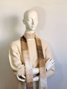 Elevate your winter ensemble with our Handmade Knit Scarf, meticulously crafted to add warmth and style to your wardrobe. This charming accessory features a blend of neutral beige and brown tones, intertwined with soft caramel, light pink, and brown shades, creating a captivating striped pattern. 🧣 Skinny Scarf Design: Embrace chic simplicity with our slim and stylish knit scarf design. Perfect for layering, this long striped scarf tie offers versatility in styling, whether loosely draped or el Brown Knitted Scarves For Fall, Brown Knitted Scarf For Fall, Knitted Brown Scarf For Fall, Brown Crochet Knitting Pattern For Fall, Brown Yarn Scarf For Fall, Brown Knitting Pattern With Knit Fabrication, Winter Crochet Knitting Pattern In Brown, Brown Crochet Knitting Pattern For Winter, Neutral Scarf