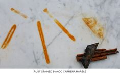 rust stained diamond carrots and an old hammer on a marble counter top with rust stains