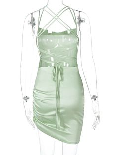 a mannequin wearing a green dress with straps on the waist and shoulder,