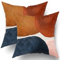 three pillows with different colored shapes on them