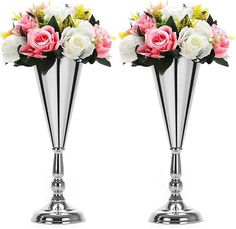 two silver vases with pink and white flowers in them are shown side by side