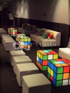 a room filled with white couches covered in colorful rubik cubes