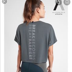 Athleta Nwt Legend Short Sleeve Short Tee “Break Record Barriers” Color: Bali Green Brand New With Tag $54.00 Size: 2x Oversized Fit, Super Soft On Body, Special Allyson Felix Graphic, Anti-Oder Technology, Moisture Wicking, Fair Trade Certified. Underarm To Underarm: 31", Back Of Neck To Hem: 23" 75% Polyester, 19% Lyocell, 7% Spandex, Super Soft!! Color: Bali Green Smoke And Pet Free Home Gray Athleisure T-shirt For Running, Sporty Athletic Fit T-shirt For Light Exercise, Sporty Gray T-shirt For Running, Athletic Heather Workout Tops With Short Sleeves, Gray Athleisure T-shirt For Training, Athletic Heather Short Sleeve Athleisure Top, Athletic Heather Short Sleeve Tops For Athleisure, Gray Go-dry Athleisure Top, Sporty T-shirt For Light Exercise