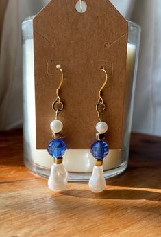 Gold and blue pearl drop earrings Handmade Blue Dangle Pearl Earrings, Blue Pearl Drop Jewelry, Blue Drop Pearl Earrings With Pearl Charm, Blue Teardrop Pearl Drop Earrings, Blue Pearl Drop Jewelry For Gift, Elegant Blue Drop Pearl Earrings, Blue Pearl Charm Drop Earrings, Blue Pearl Charm Earrings As Gift, Blue Dangle Pearl Earrings