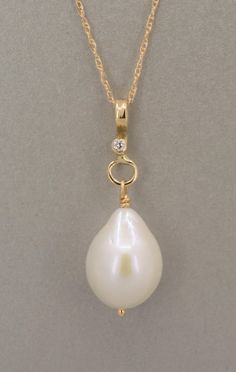 Large white baroque shape freshwater pearl pendant in solid gold.  This classic and timeless piece has a beautiful and luminous high quality natural freshwater pearl with a very smooth surface.  The pearl has a slight teardrop baroque shape and dangles from a 14K solid gold handmade pendant with a diamond also set in 14K gold.  The pendant is shown with two different chains a rope chain and a cable chain.  Both are solid 14K gold and are sold separately. You can also use your own chain.  The bai Anniversary Pearl Charm Drop Jewelry, Graceful Teardrop Jewelry For Anniversary, Yellow Gold Drop Jewelry With Single Diamond, Elegant Teardrop Single Diamond Jewelry, Anniversary Drop Pearl Charm Jewelry, Classic Drop Jewelry With Single Diamond, Drop Jewelry With Single Diamond For Anniversary, Drop-shaped Single Diamond Jewelry For Anniversary, Drop Shaped Single Diamond Jewelry For Anniversary