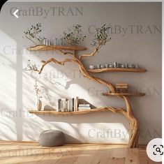 a wooden shelf with books and vases on it next to a wall mounted tree