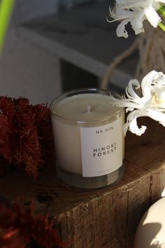 a white candle sitting on top of a wooden table