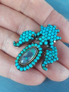 "ATTENTION BUYERS.. PLEASE READ ANNOUNCEMENT IN MY SHOP. it's very important information there about purchasing items. Must purchase thru Etsy only, NOT from \" Offsite ads\"Absolutely Stunning 14k Yellow Gold Victorian Brooch with Black Opal and Turquoise Pave. Brooch is in Good Antique Pre Owned Condition. all sales are final. some pics ENLARGED to see details .. Weight is 10 Grams. YOU MUST TO READ ANNOUNCEMENT IN MY SHOP PLEASE.ATTENTION BUYERS ALL ITEMS FROM MY SHOP MUST BE PURCHASED STRAIG Elegant Turquoise Brooches For Collectors, Turquoise Cabochon Brooch As A Gift, Turquoise Cabochon Brooch For Gift, Turquoise Brooch Jewelry Gift, Handmade Turquoise Brooches For Collectible, Victorian Brooch, Black Opal, Flower Design, Gold Black